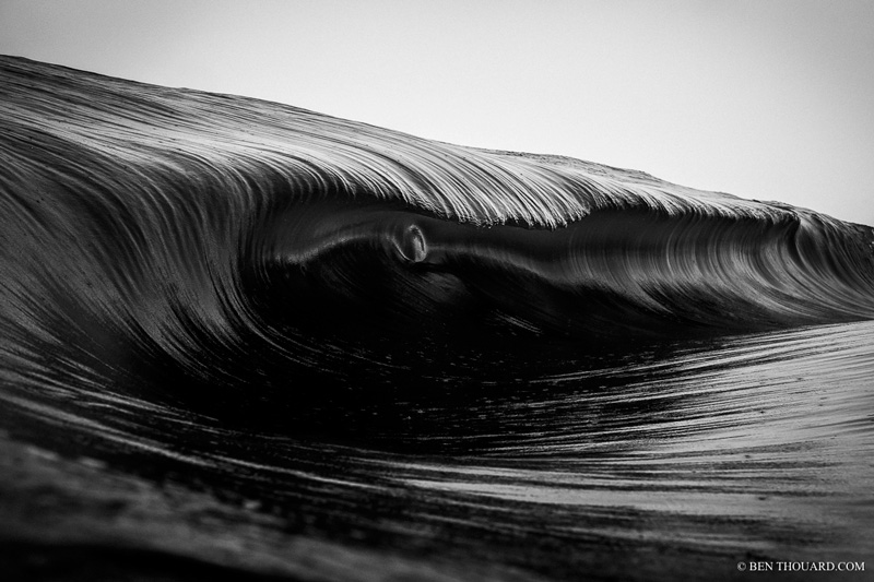 It was very dark and rainy this day and the waves were breaking on a really shallow reef with lot of energy. The shallow reef combined with the energy created that little bubble in the wave. Canon 1DX + 50 mm f/1.2, Aquatech Delphin 1D housing + P80 front port. ISO 200, f/4, 1/1600