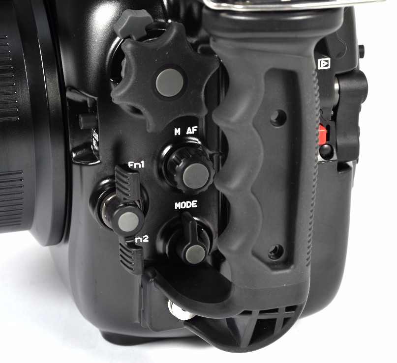 The new AF-Mode Lever is a significant improvement, and one based on feedback from Nauticam customers in the field. Nikon AF Area modes have become so powerful that shooters are regularly switching between 3D Tracking, Auto Area AF, and Single Area modes. The AF-Mode lever is now easily located by feel from the left handle! The less critical AF-M lever has been replaced by a knob, making it less likely to be inadvertently bumped into manual focus. Fn1 and Fn2 are also located here, accessed by an oversized rocker just forward of the handle. These assignable controls can be mapped to one of numerous functions for quick access.