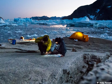 My friend Vincent Berthet and I trace our journey on a map of Greenland at one of our base camps. Photo: Andy Parant