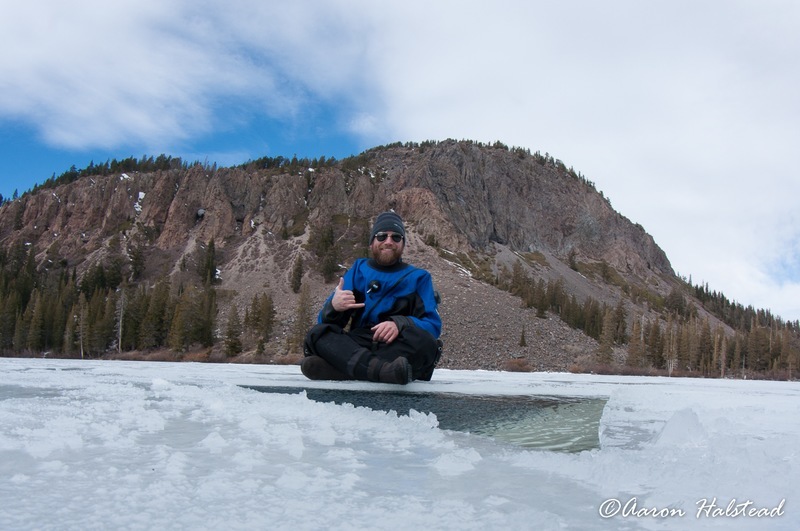 Waiting to gear up at the edge of the freshly cut hole in the ice.
